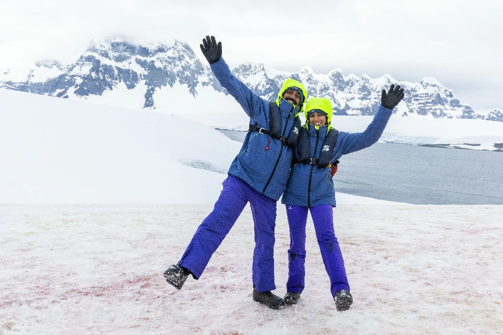 TRIPS - couple waving Antarctica landing portal point